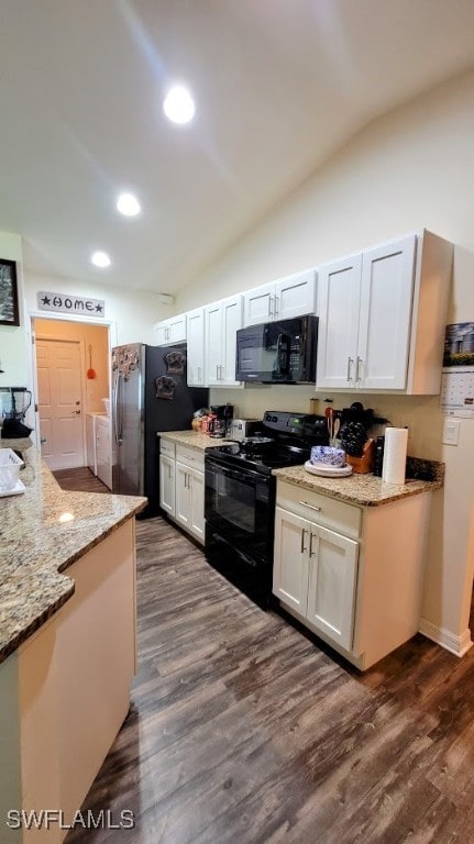 kitchen featuring black appliances, lofted ceiling, white cabinetry, and dark wood-type flooring