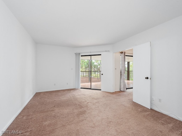 unfurnished room featuring light carpet