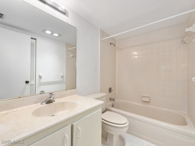 full bathroom featuring tiled shower / bath combo, vanity, toilet, and tile patterned floors