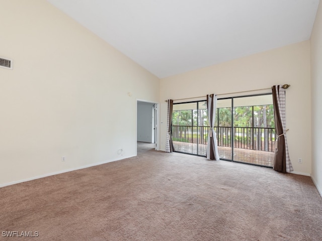 unfurnished room featuring light colored carpet and high vaulted ceiling