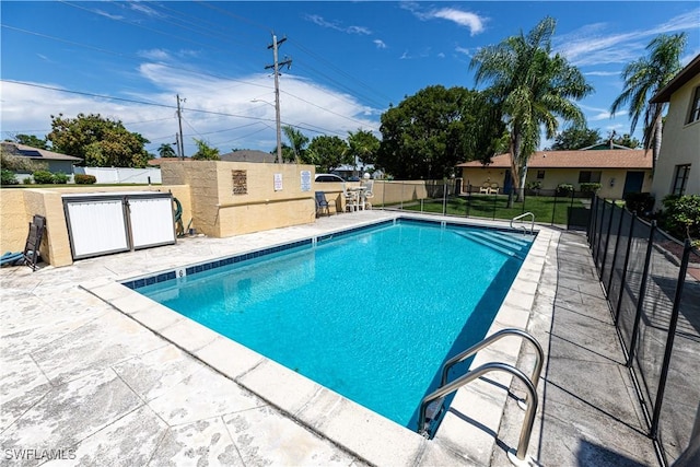 community pool featuring fence and a patio