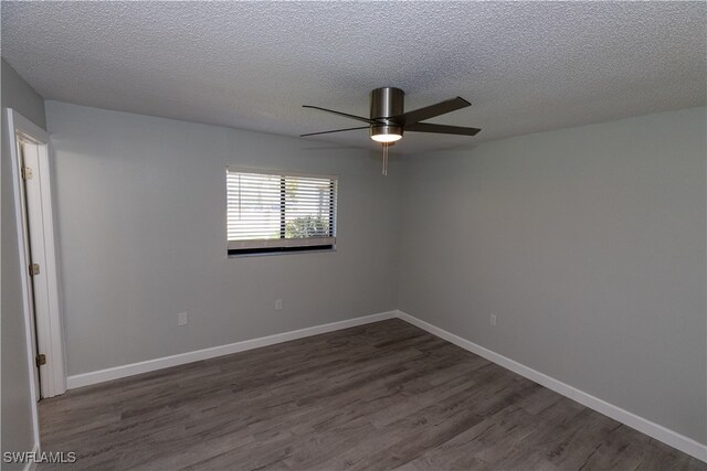 unfurnished room featuring dark wood finished floors, a textured ceiling, baseboards, and ceiling fan