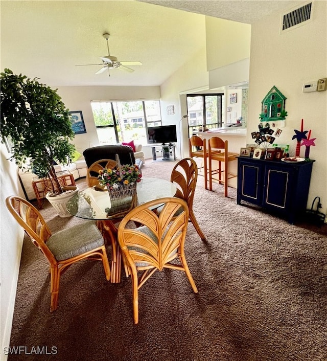 dining room with carpet, vaulted ceiling, and ceiling fan