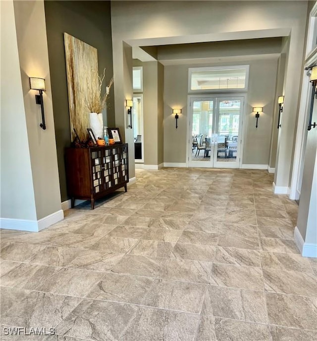 5925 Trailwinds Dr Unit 926, Fort Myers, FL 33907 - corridor with baseboards and french doors