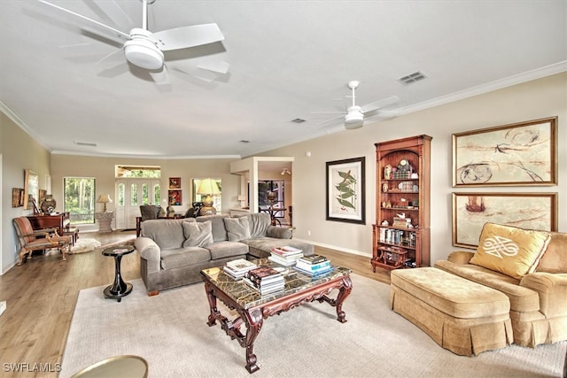 living room with crown molding, ceiling fan, and light hardwood / wood-style flooring