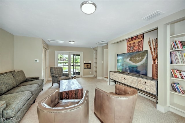 living room featuring light colored carpet and built in features