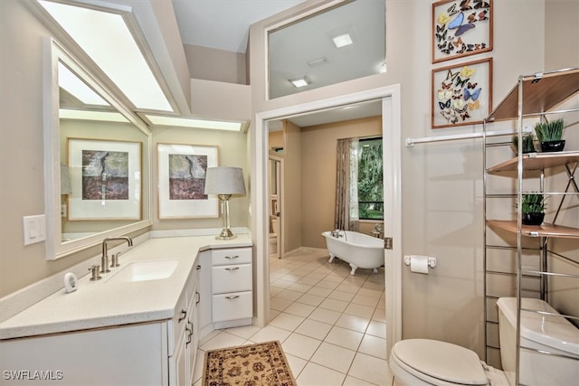 bathroom with a bathing tub, tile patterned floors, vanity, and toilet