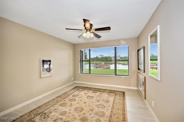 unfurnished room featuring light wood-type flooring, ceiling fan, and a wealth of natural light