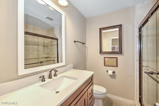 bathroom with walk in shower, vanity, tile patterned flooring, and toilet