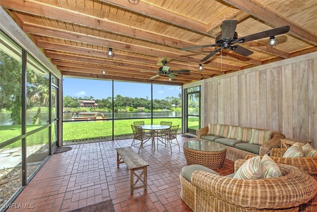 sunroom featuring wood ceiling, a water view, and ceiling fan