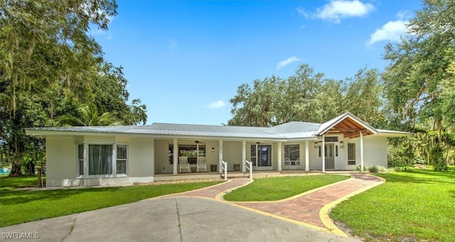 back of house featuring a lawn