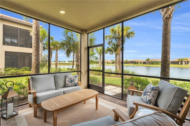 sunroom with a wealth of natural light and a water view