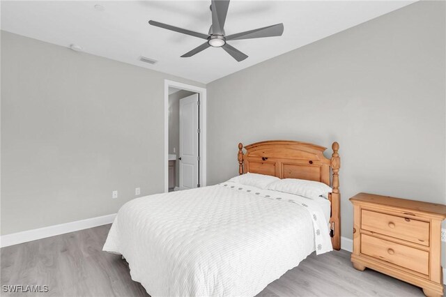 bedroom with light hardwood / wood-style floors and ceiling fan