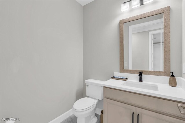 bathroom with vanity and toilet