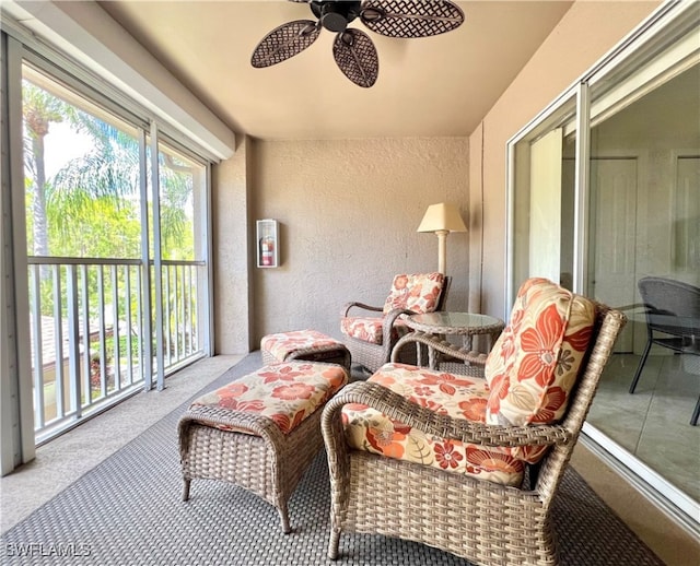 sunroom / solarium featuring ceiling fan