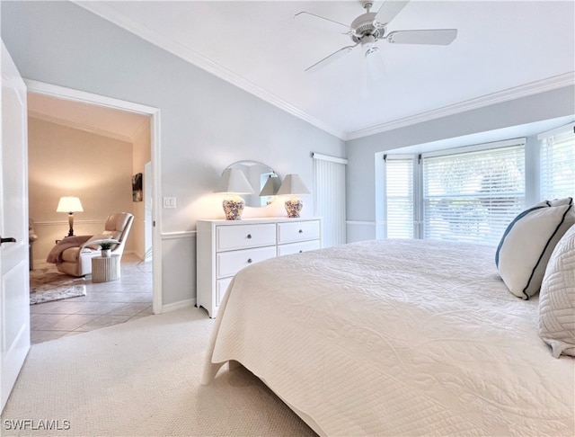 bedroom featuring ornamental molding, vaulted ceiling, ceiling fan, and light colored carpet