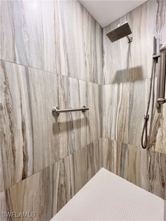 bathroom with tiled shower