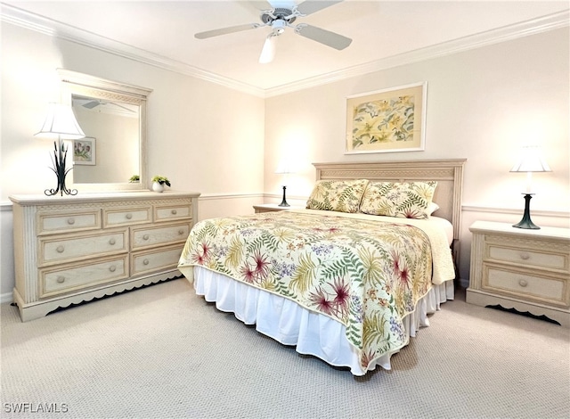 bedroom featuring ornamental molding, ceiling fan, and light colored carpet