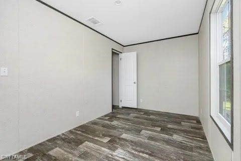 spare room featuring dark wood-type flooring