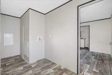 clothes washing area featuring dark hardwood / wood-style flooring