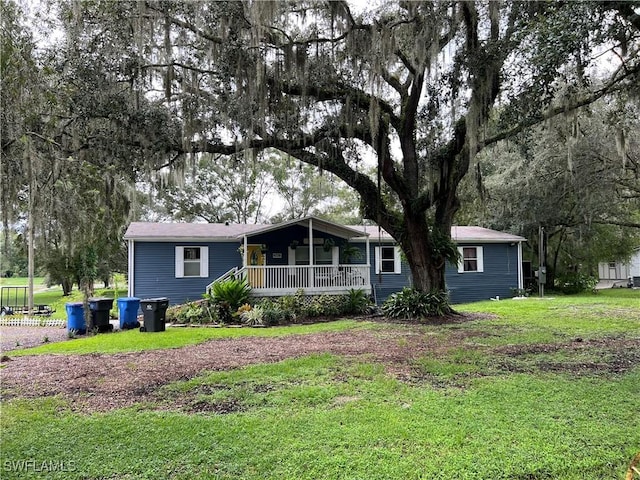 view of front facade with covered porch and a front lawn