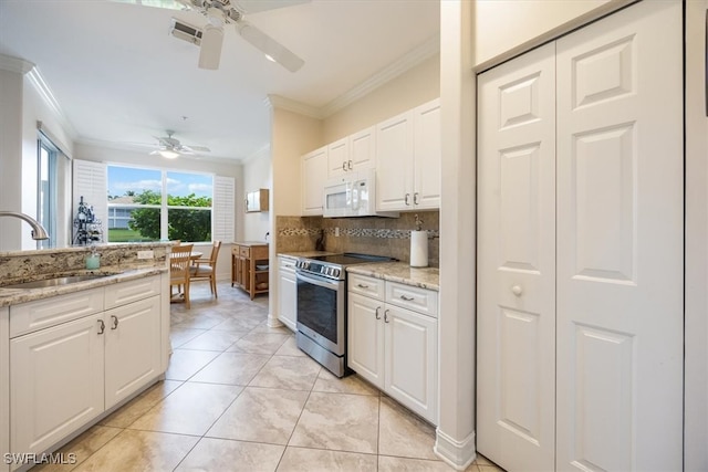 kitchen featuring ornamental molding, stainless steel range with electric stovetop, ceiling fan, and white cabinets