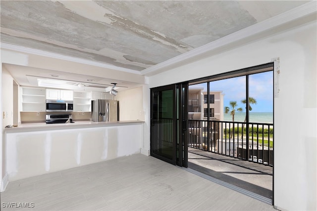 kitchen featuring a water view, ceiling fan, stainless steel appliances, and white cabinets