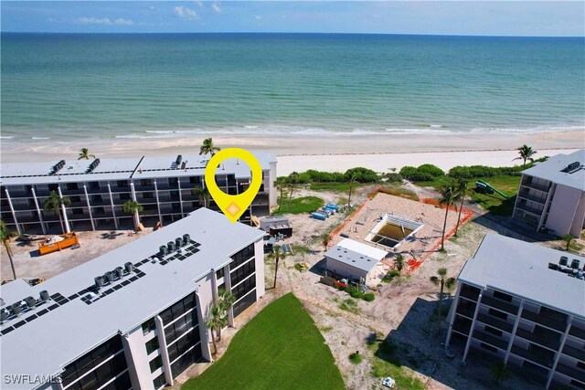 birds eye view of property featuring a water view and a view of the beach