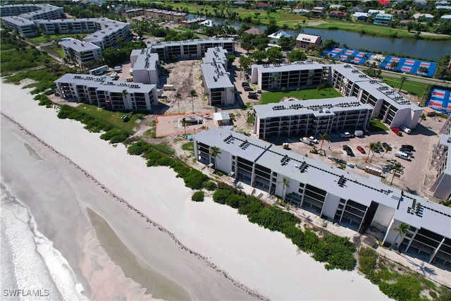 birds eye view of property with a view of the beach and a water view