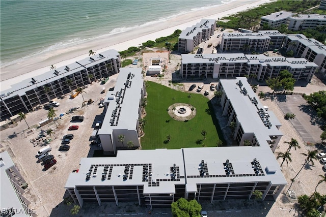 drone / aerial view featuring a water view and a beach view