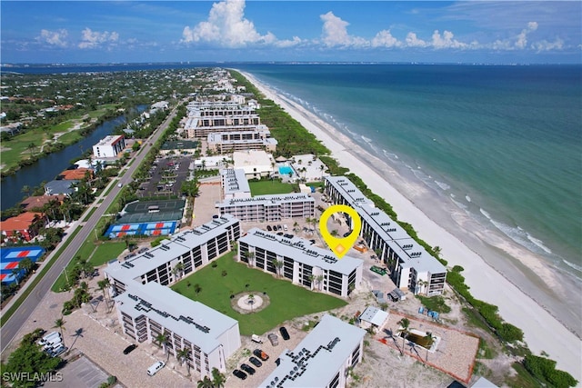 drone / aerial view with a water view and a view of the beach