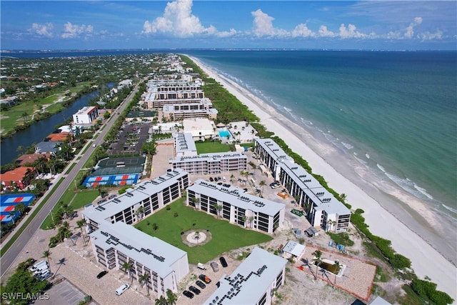 aerial view with a water view and a beach view