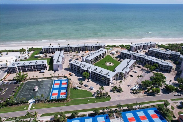 drone / aerial view featuring a water view and a view of the beach