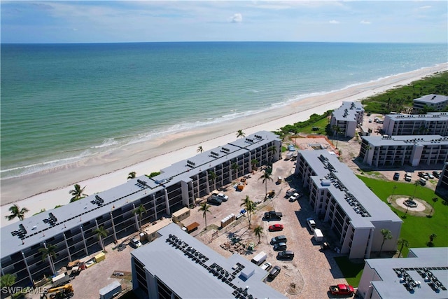 drone / aerial view with a beach view and a water view