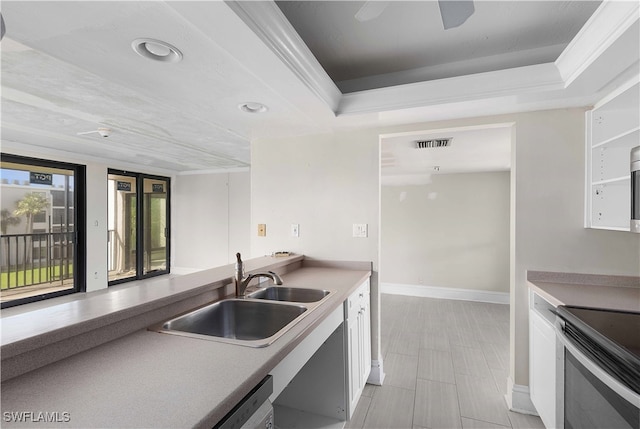 kitchen with dishwashing machine, white cabinetry, sink, and ceiling fan