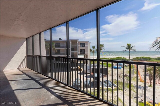 balcony with a view of the beach and a water view