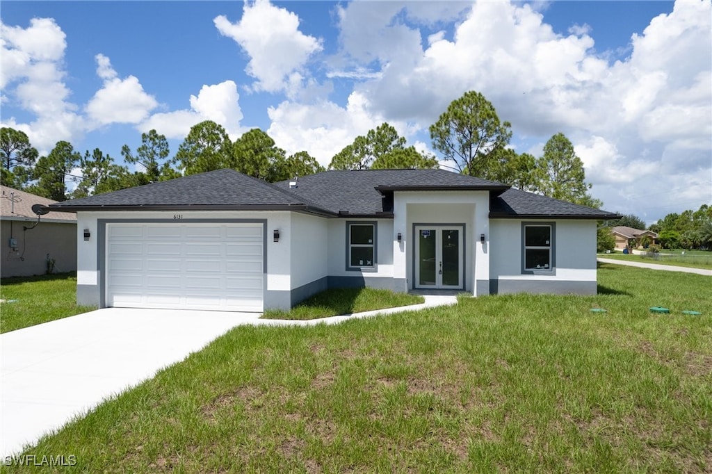 view of front of property with a garage and a front lawn