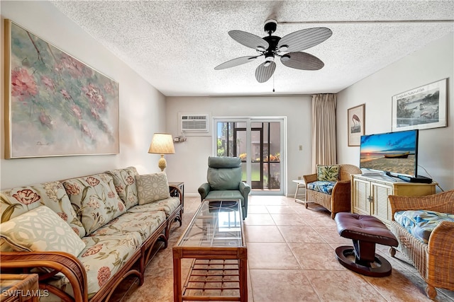 living room featuring a textured ceiling, light tile patterned floors, ceiling fan, and a wall unit AC