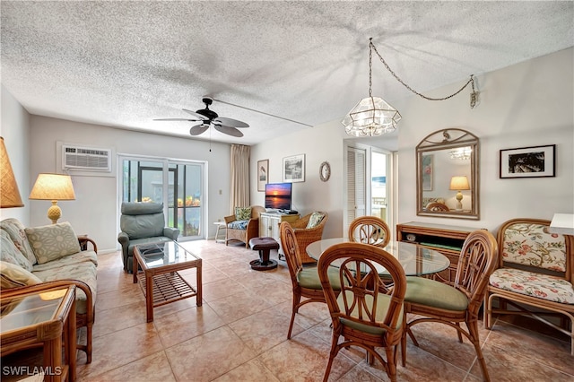 dining space featuring a textured ceiling, ceiling fan with notable chandelier, light tile patterned floors, and an AC wall unit