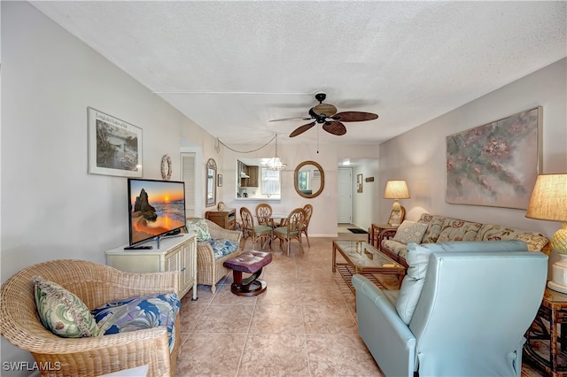 tiled living room featuring ceiling fan and a textured ceiling