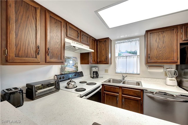 kitchen featuring a skylight, sink, white range with electric stovetop, and stainless steel dishwasher