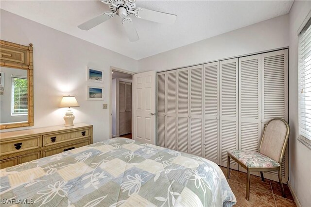 bedroom with ceiling fan and a closet