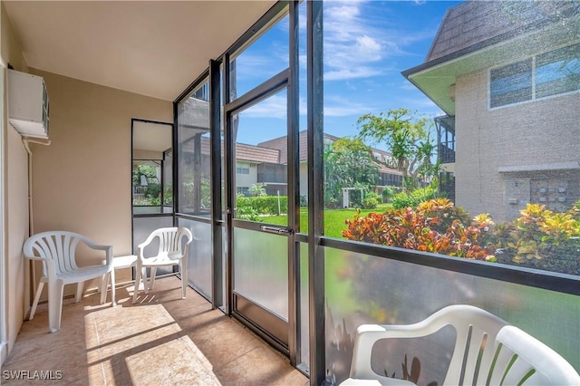 sunroom featuring a wall of windows and an AC wall unit