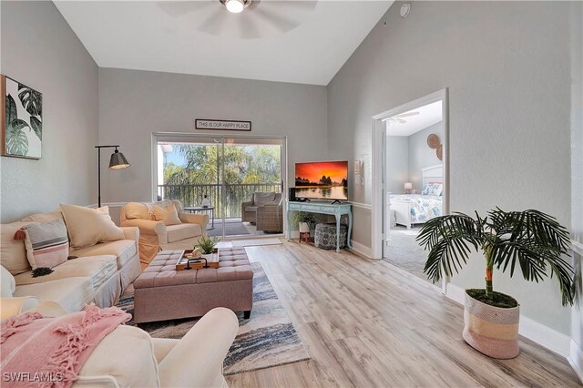 living room with lofted ceiling, light hardwood / wood-style floors, and ceiling fan