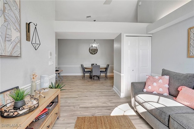 living room with an inviting chandelier and light hardwood / wood-style floors