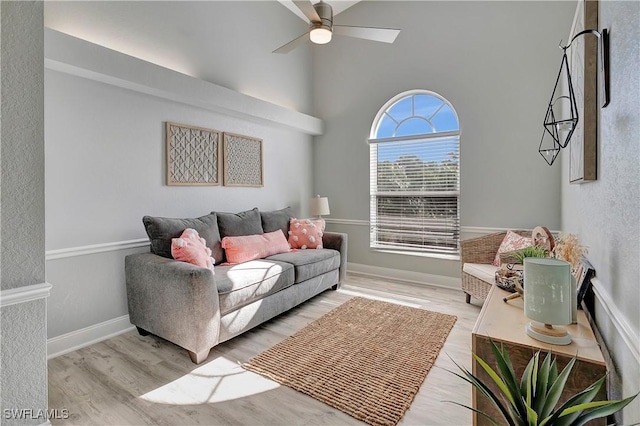 living room featuring ceiling fan and light hardwood / wood-style flooring