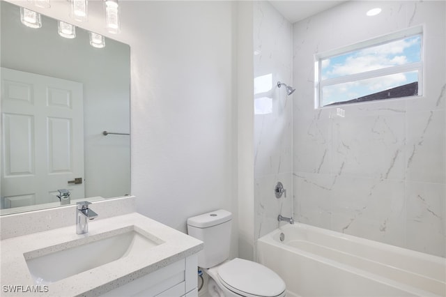 full bathroom featuring tiled shower / bath, vanity, and toilet