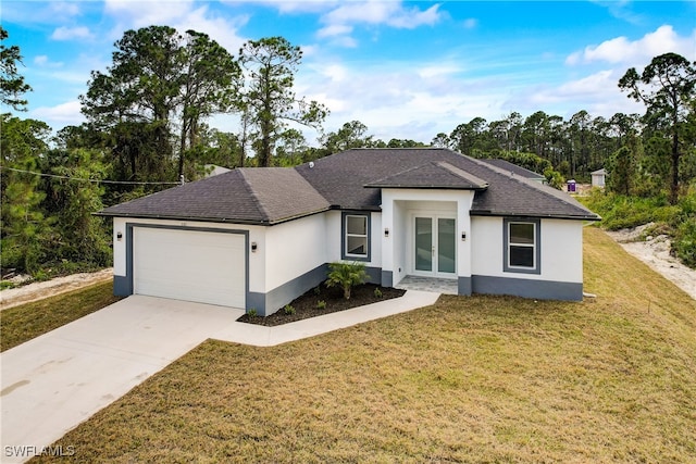 view of front of property with a front yard and a garage