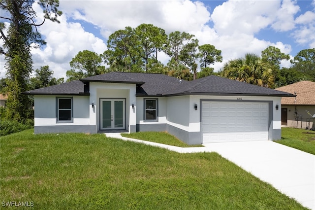 view of front of house with a garage and a front lawn