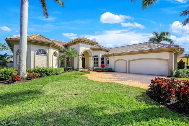 mediterranean / spanish-style home with a garage and a front yard